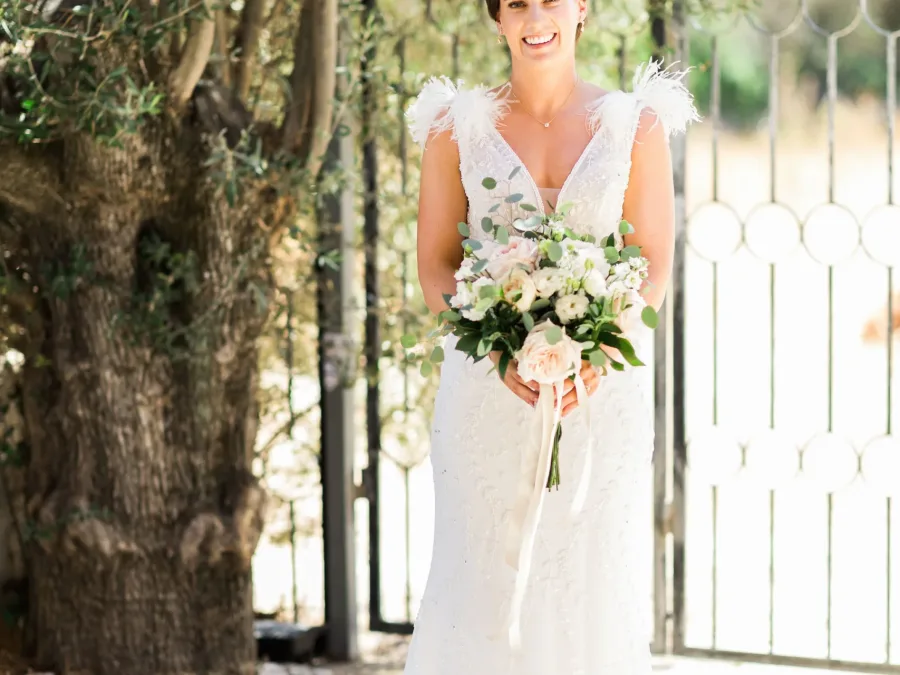 Bride standing alone in her wedding dress at Monte do Serrinho, Algarve, Portugal — captured in a quiet moment before the ceremony