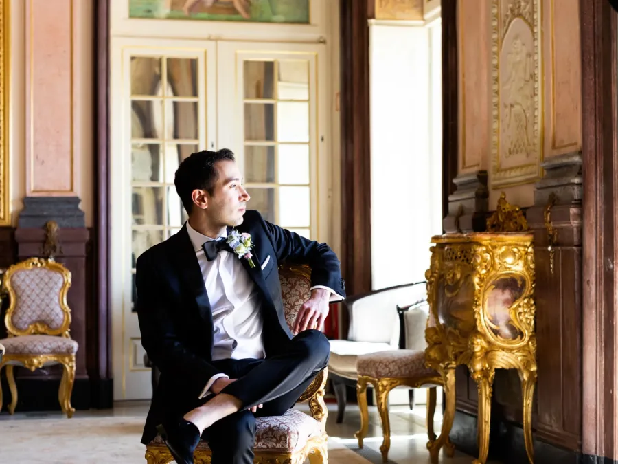 groom at estoi palace on wedding day