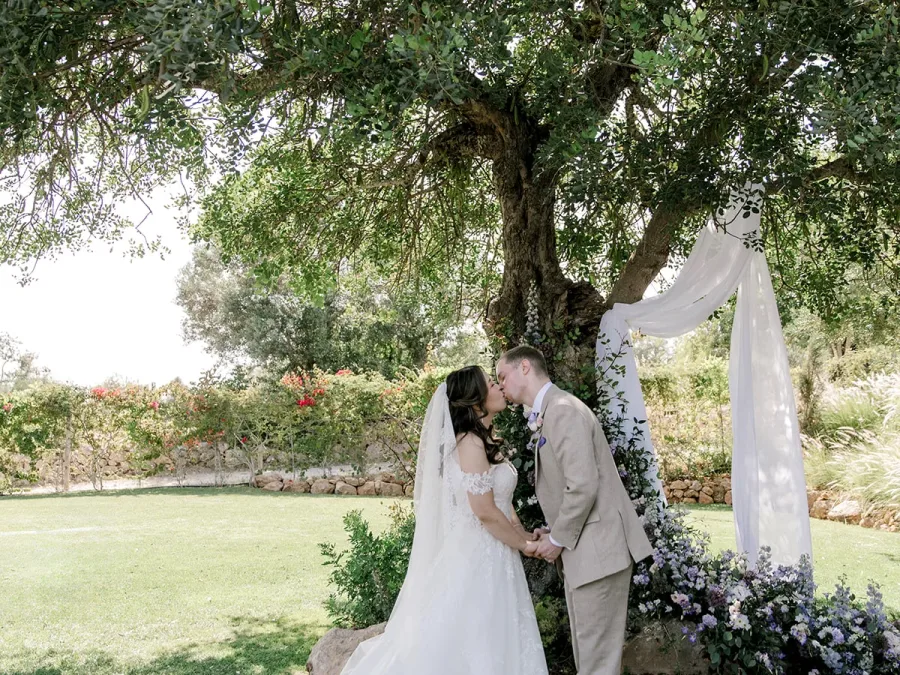 bride and groom at the altar kissing